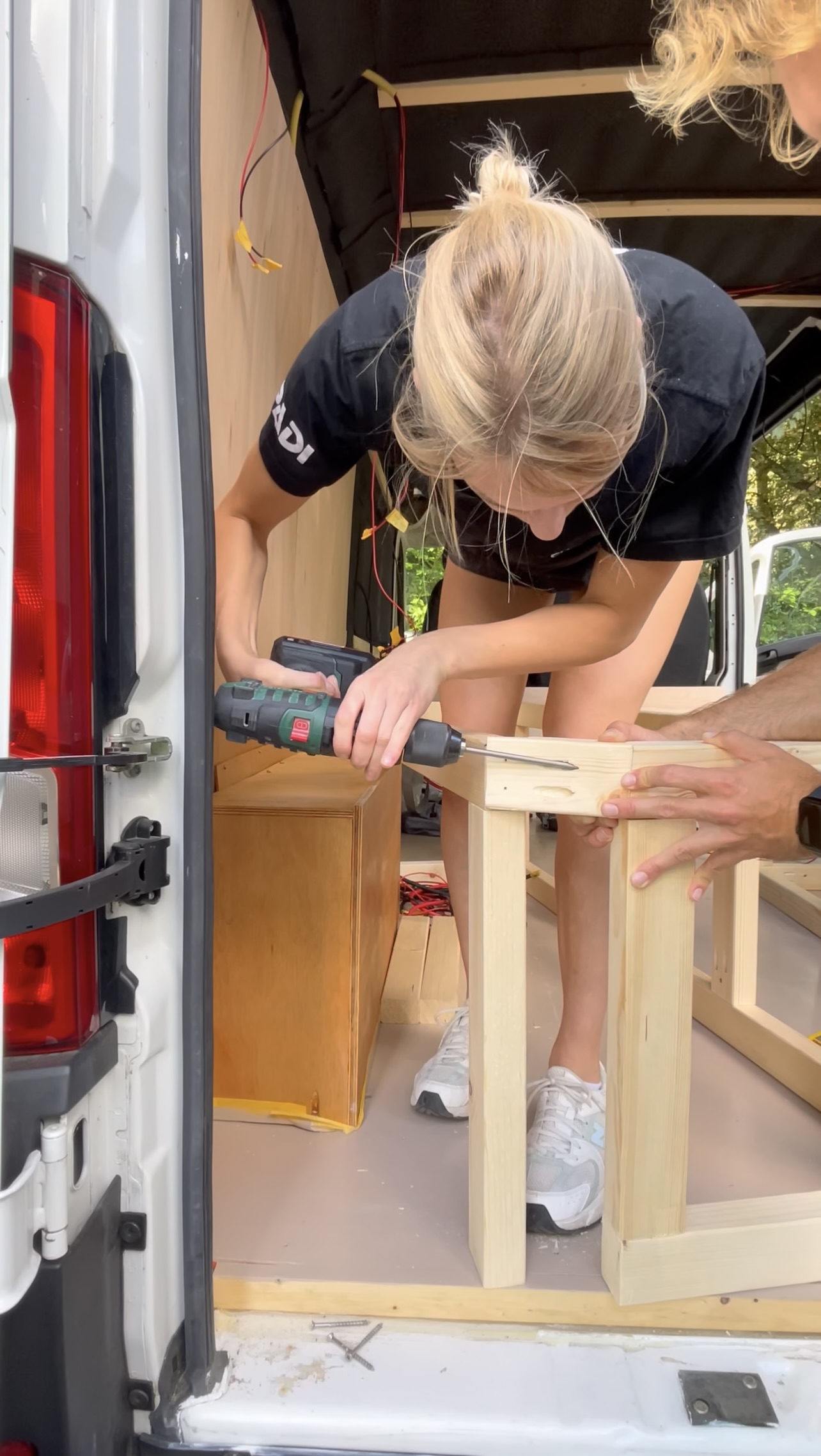 Saskia presenting the van with arms wide open
